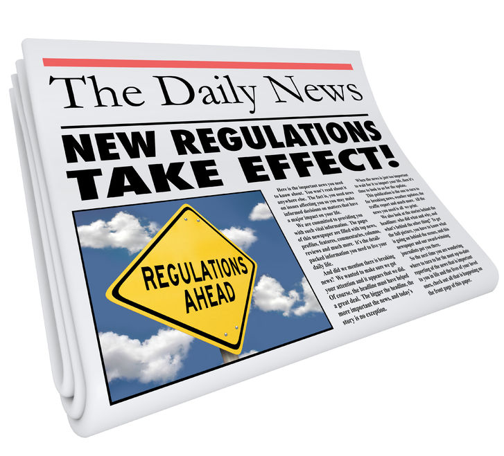 This is a picture of a folded newspaper titled "The Daily News" with the article title alluding to compliance entitled "New Regulations Take Effect!"